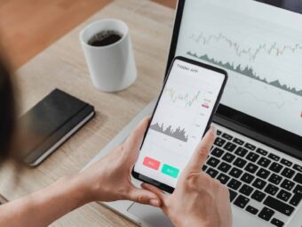 Forex trader using crypto exchange mobile phone app for investment and stock market analysis at hedge fund office - Focus on screen